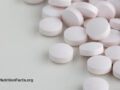 a bunch of white vitamin B12 tablets on a white table