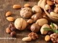 Assorted nuts on a wooden surface