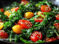 A mixed greens and tomato sauté in a pan