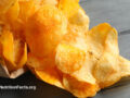 Potato chips spilling from a paper bag