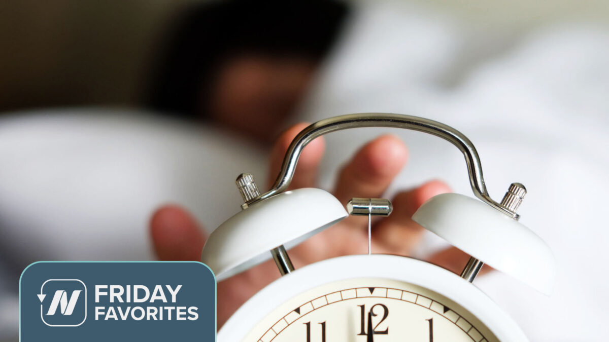 Hand reaching for an alarm clock