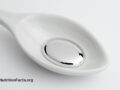 White spoon holding liquid mercury on a white background