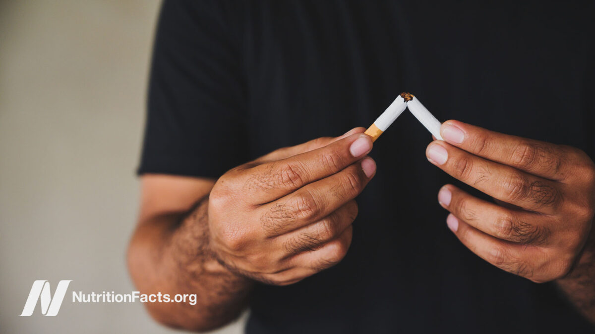 Person breaking a cigarette in half