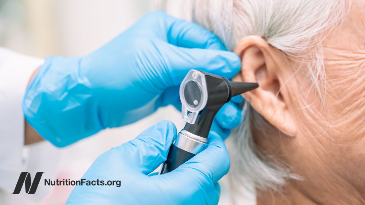 Doctor hands performing an otoscopy in a patients ear
