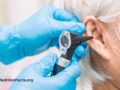 Doctor hands performing an otoscopy in a patients ear