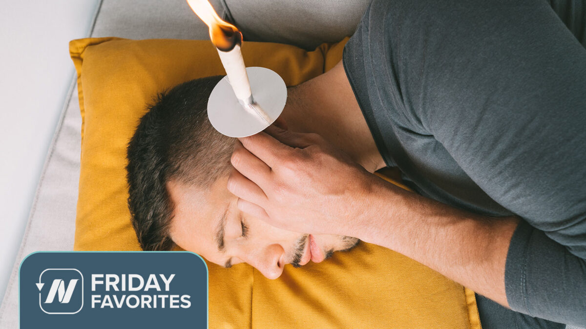 Person laying on their side with a lit ear candle