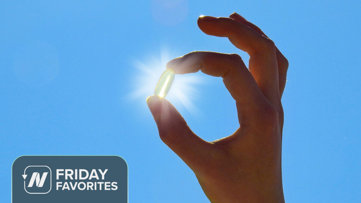 Person positioning fingers to make it appear as if they are holding the sun