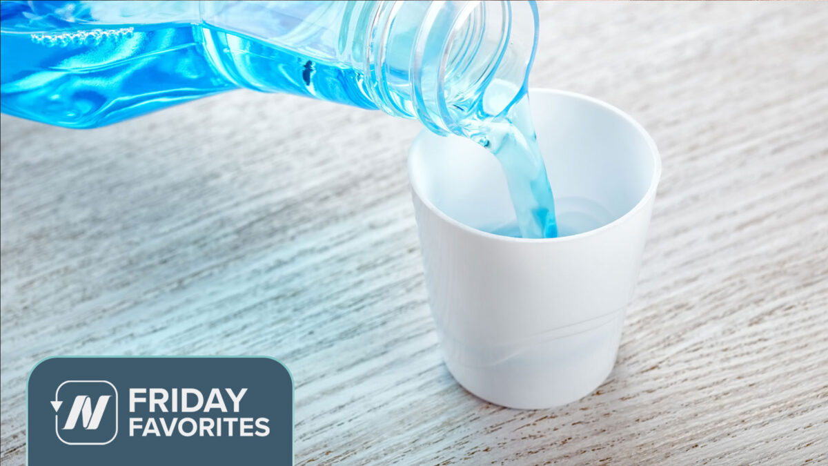 Pouring mouthwash in a small white cup